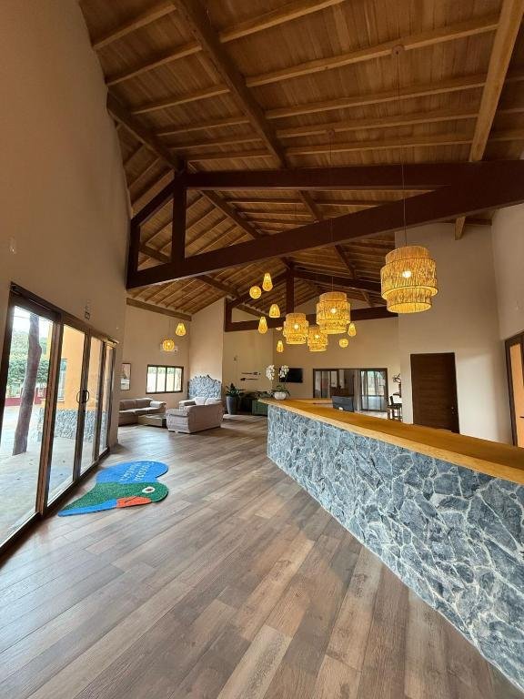 The inn's lounge with a high ceiling and a wooden roof