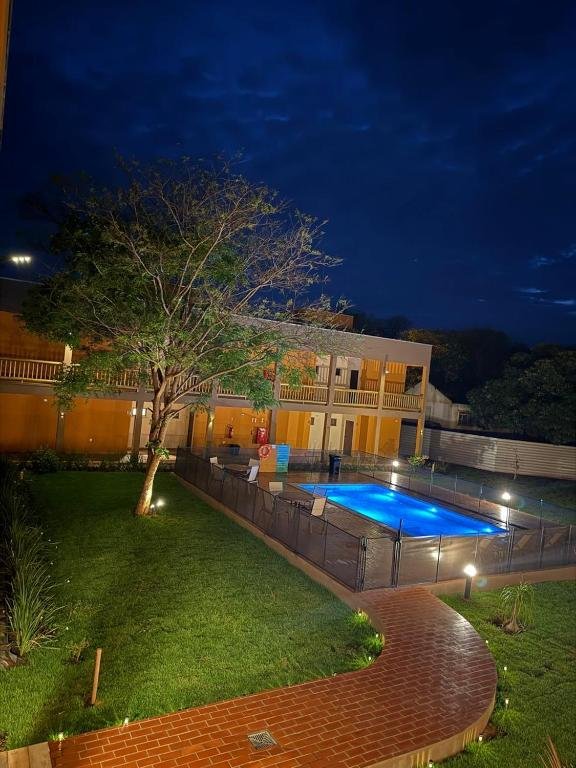 The garden and the lit pool in the late afternoon