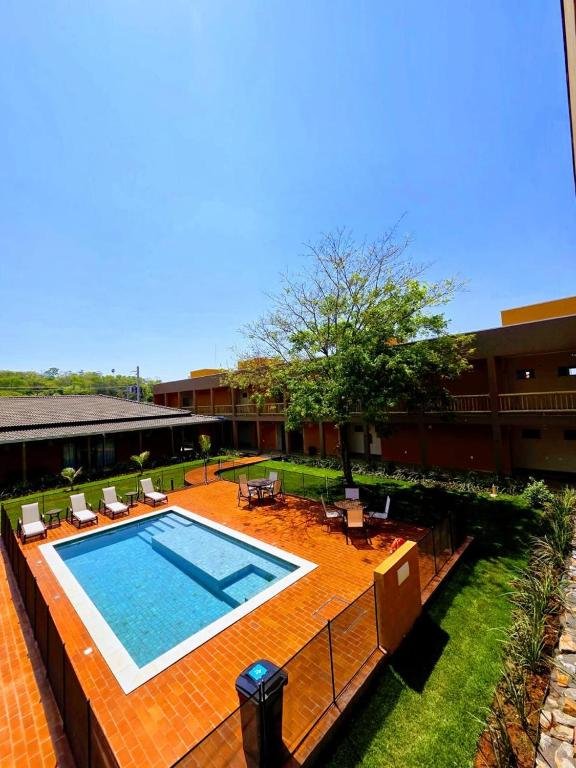 View of the pool and the garden with the suites behind them